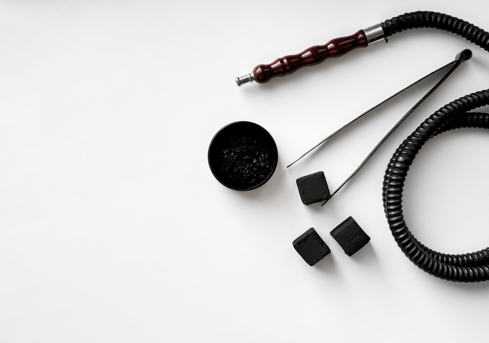 hookah accessories arrangement with charcoal on white background.